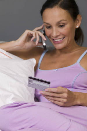 woman-using-credit-card-and-ordering-by-cell-phone-17ac46.jpg
